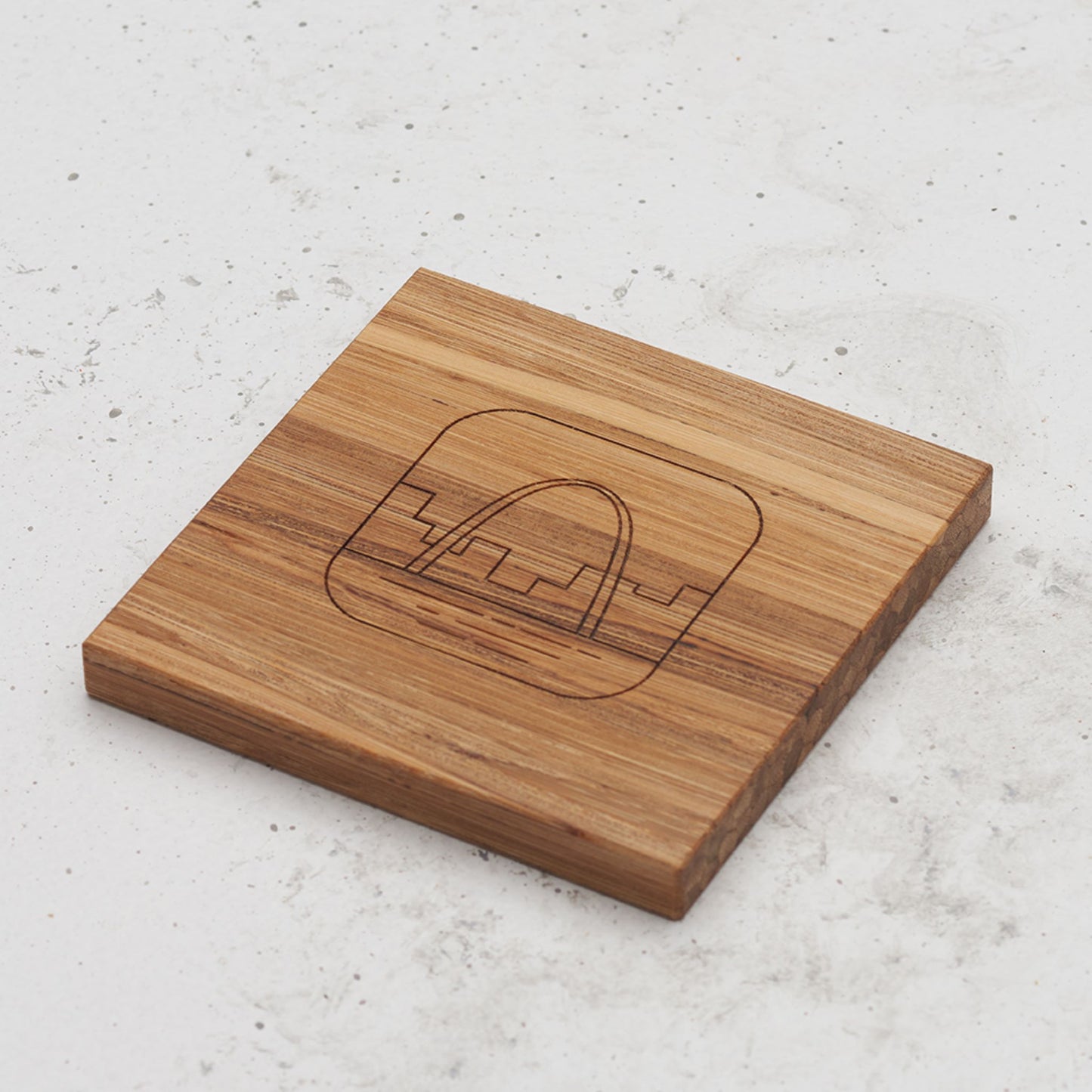 An overhead view of one of the US landmark themed all day every day coasters with the arch engraved in the middle