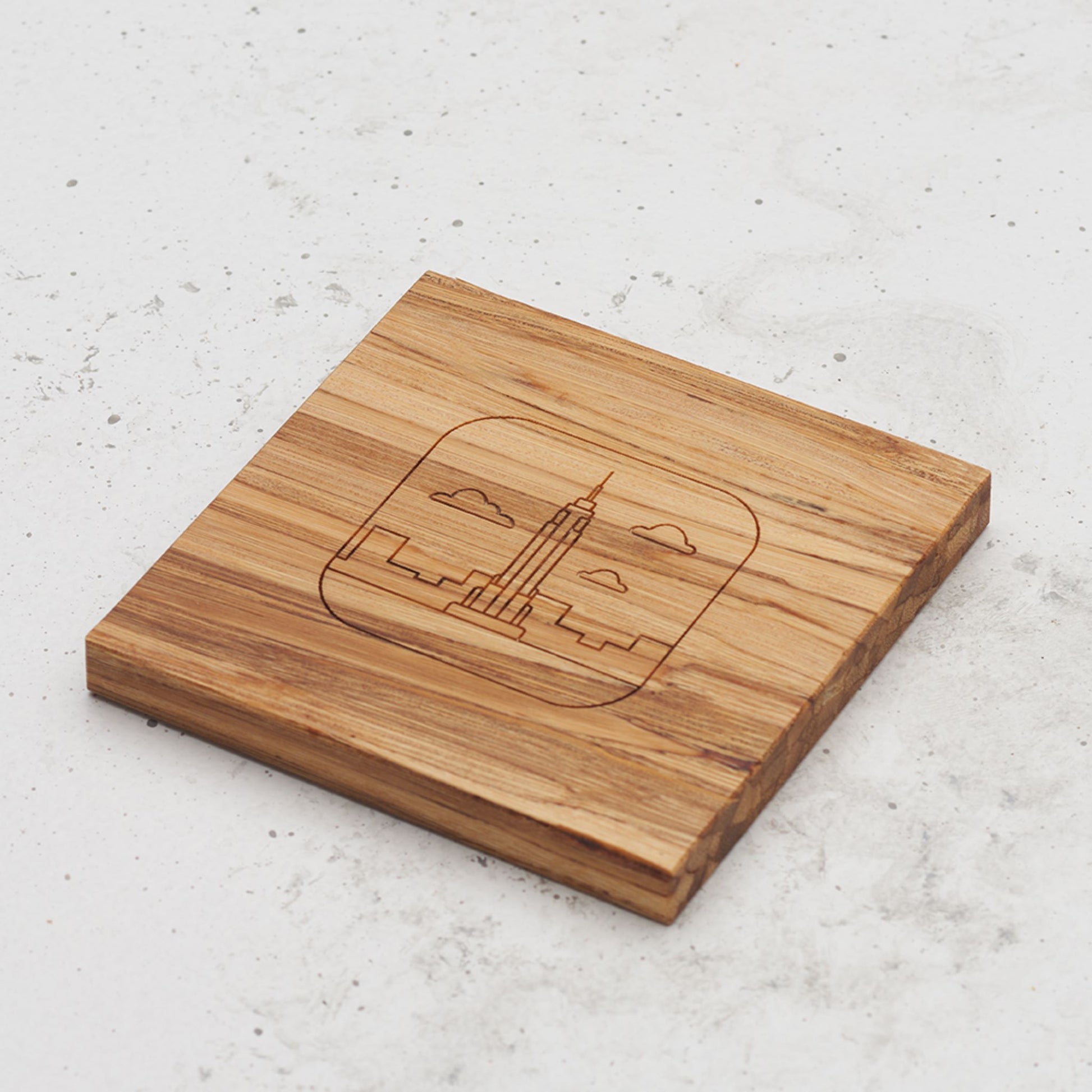 An overhead view of one of the US landmark themed all day every day coasters with the Chrysler building engraved in the middle