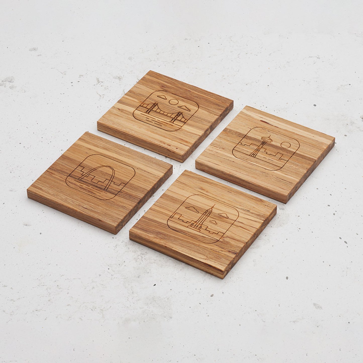 An overhead view of the entire US landmark themed all day every day coasters each one featuring a different landmark. One features the Chrysler building, one the space needle, one the golden gate bridge and the other the Arch.