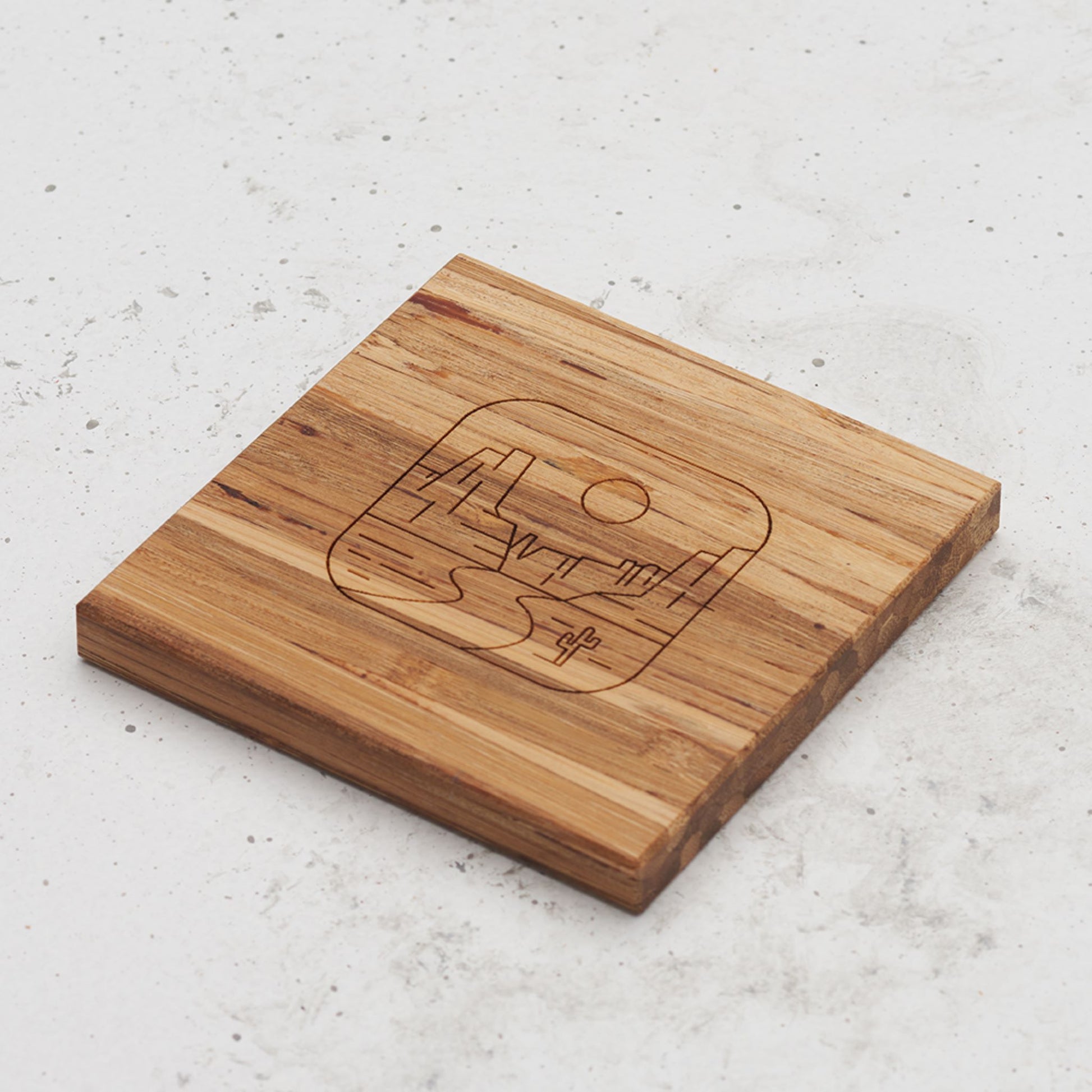 An overhead view of one of the all day every day coasters with an engraved image of Monument Valley in the middle