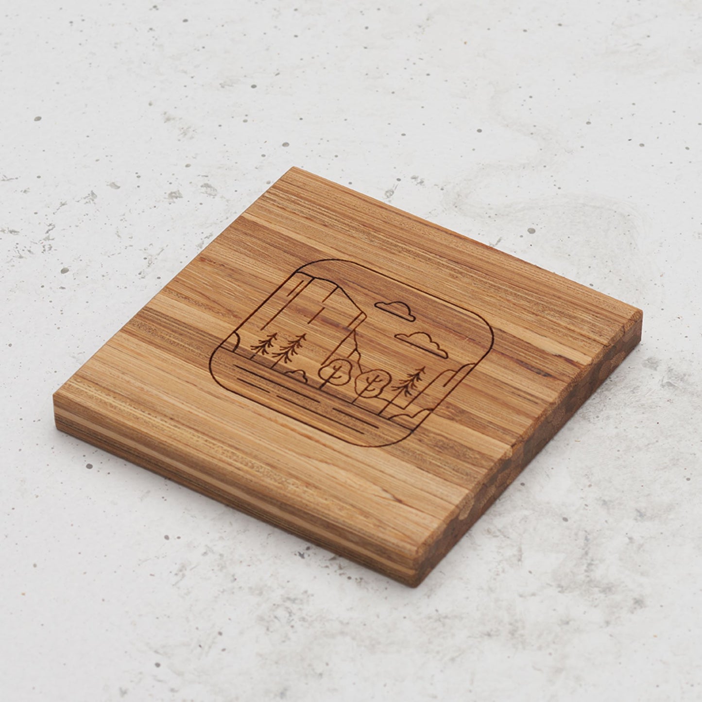 An overhead view of one of the all day every day coasters with an engraved image of Yosemite in the middle