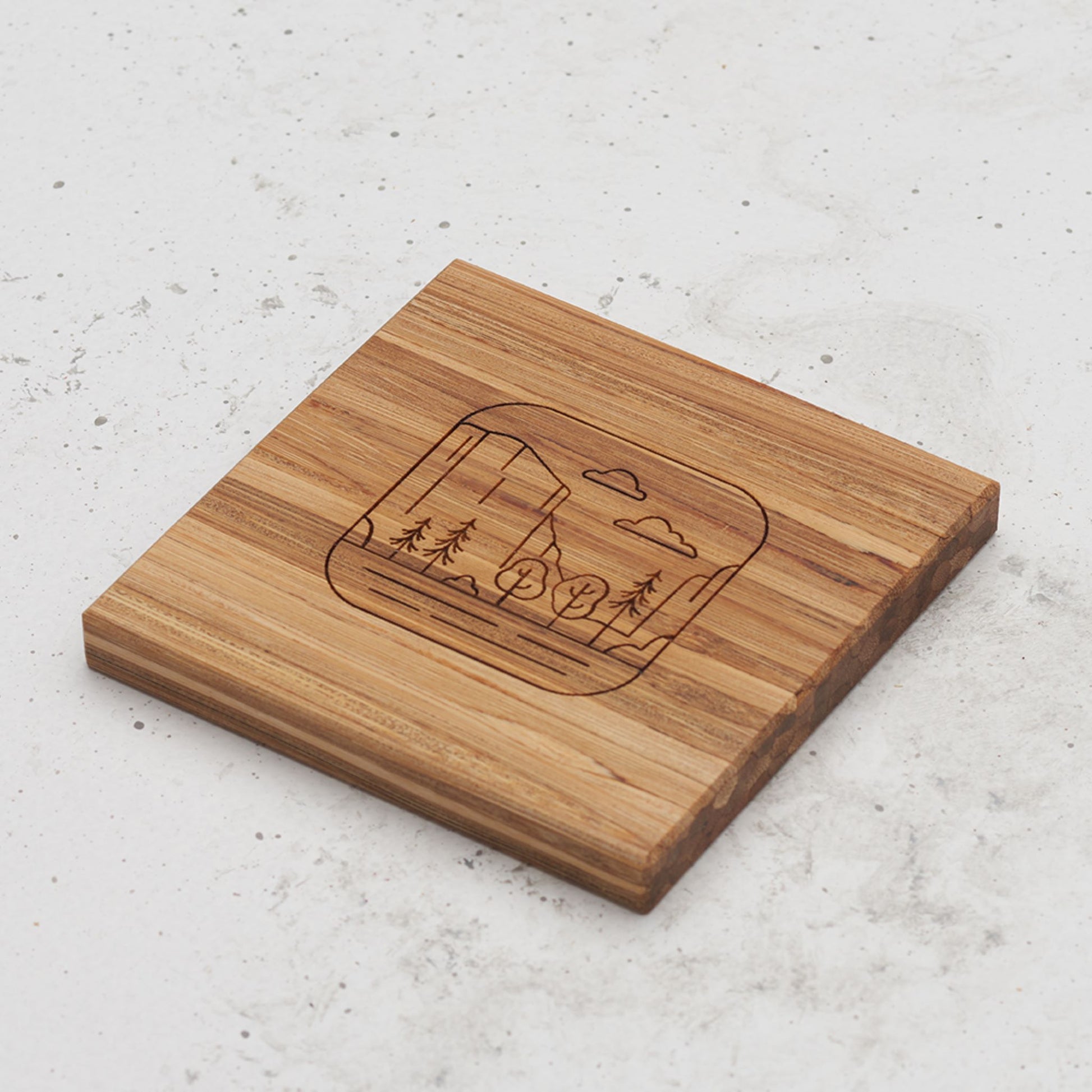 An overhead view of one of the all day every day coasters with an engraved image of Yosemite in the middle