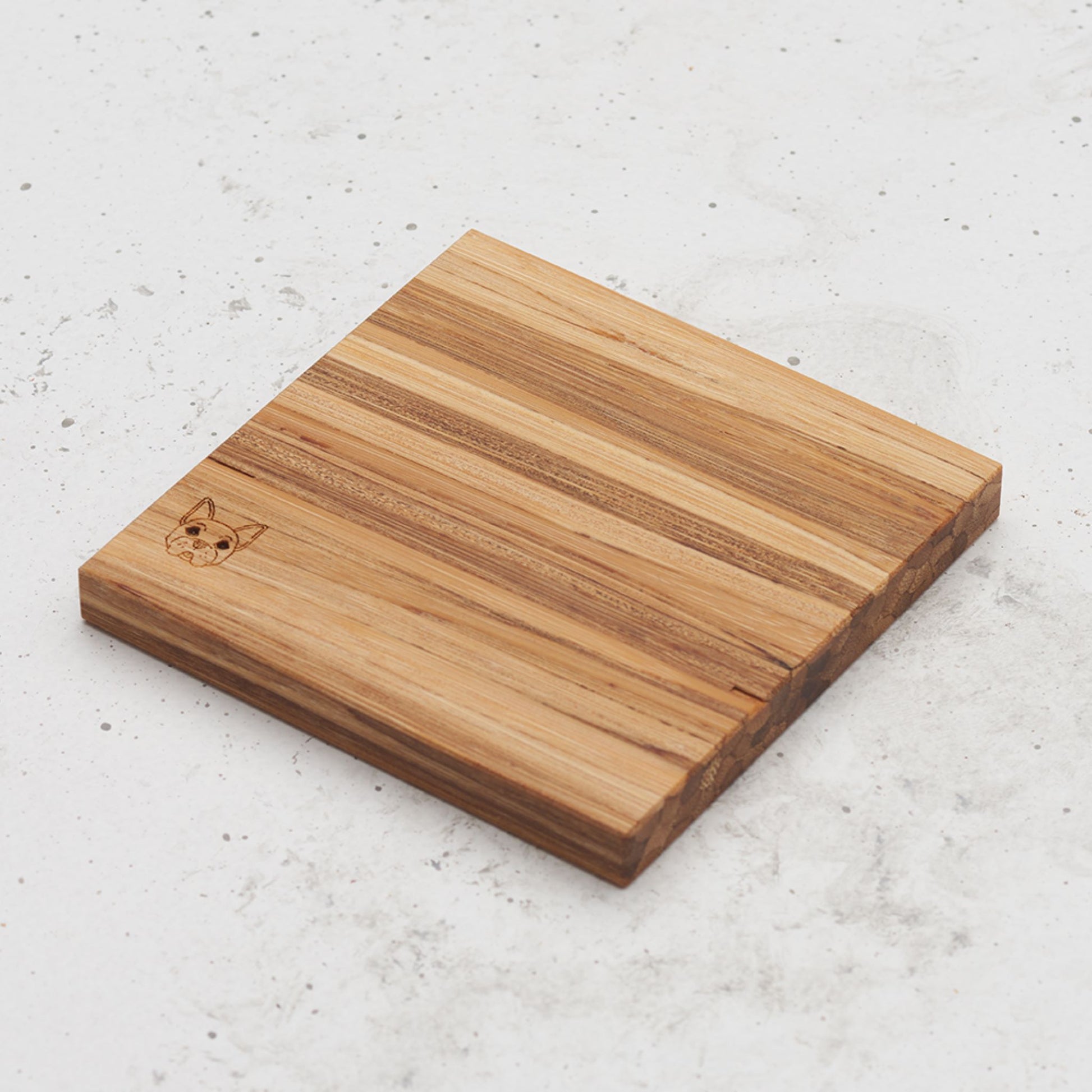 An overhead view of one of the dog themed all day every day coasters with the image of a dog's head in the bottom left corner