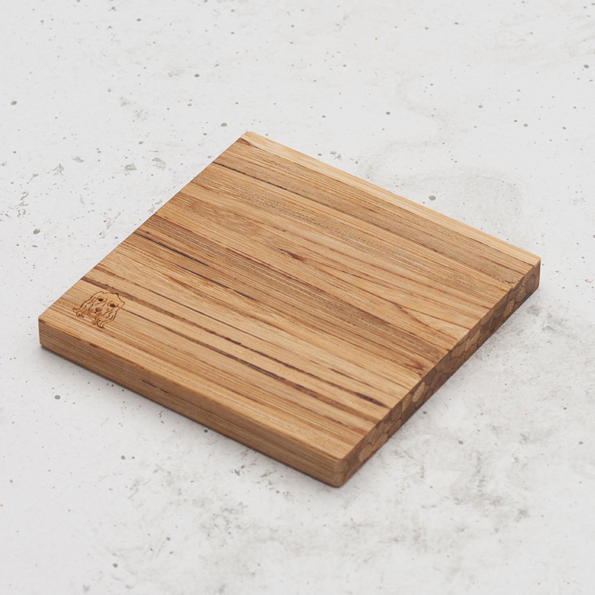 An overhead view of one of the dog themed all day every day coasters with the image of a dog's head in the bottom left corner