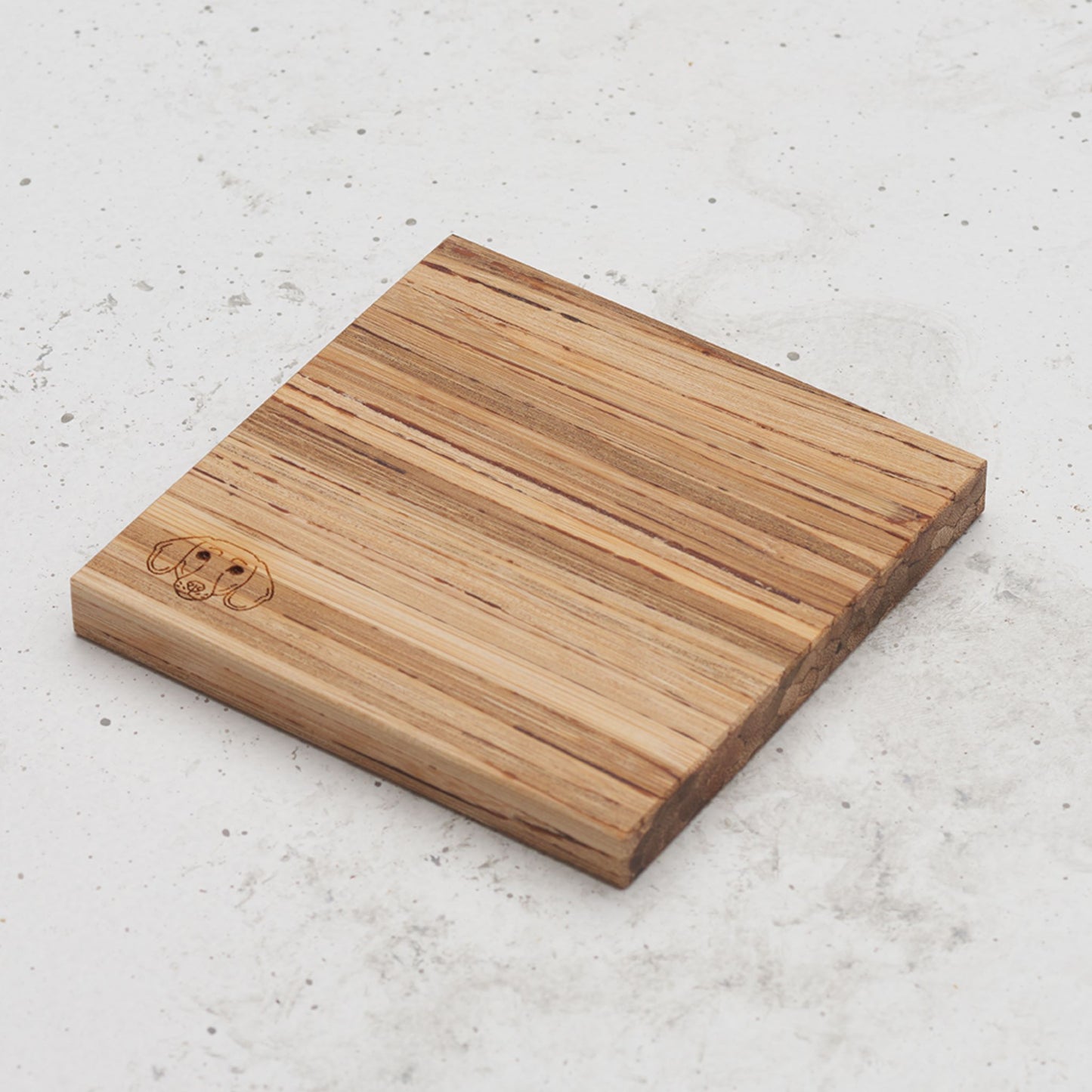 An overhead view of one of the dog themed all day every day coasters with the image of a dog's head in the bottom left corner