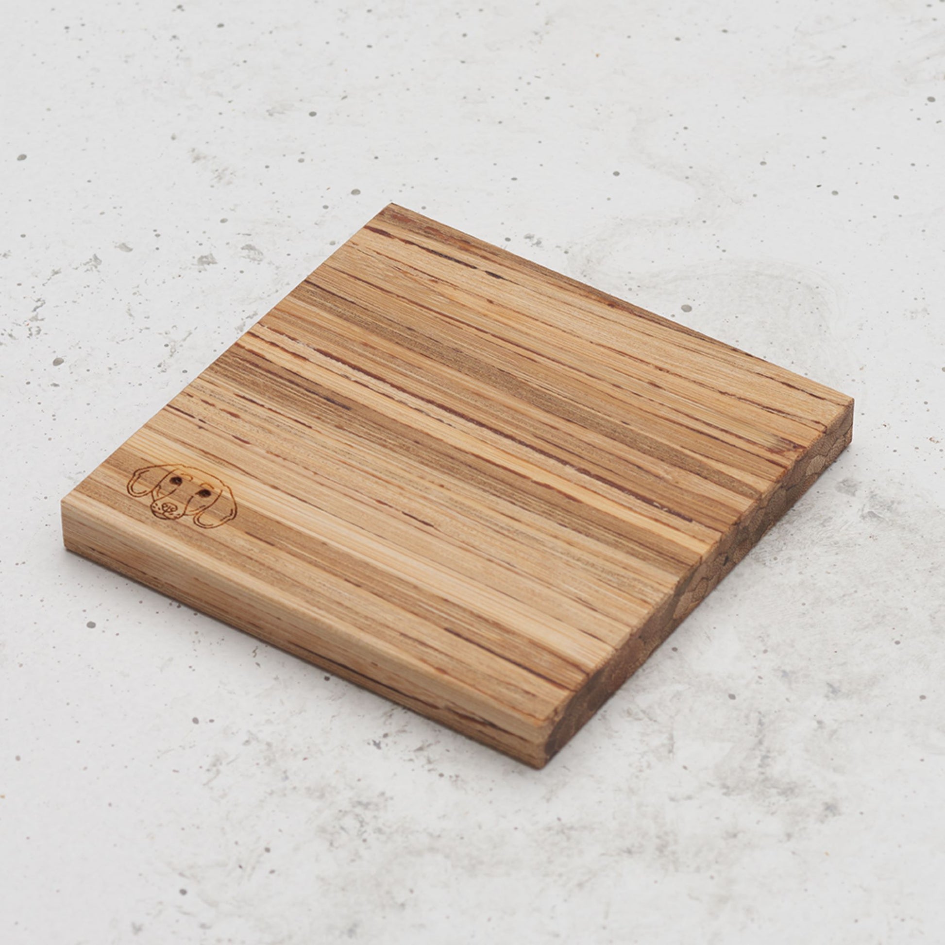 An overhead view of one of the dog themed all day every day coasters with the image of a dog's head in the bottom left corner