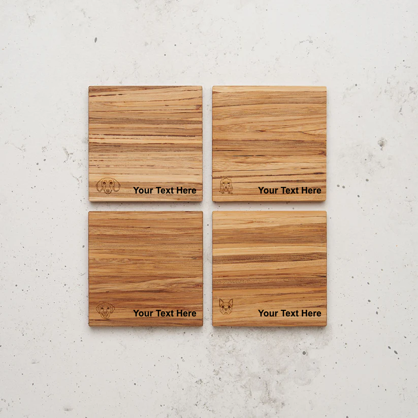 An overhead view of the backside of the entire dog themed all day every day coaster set sitting on a counter. Each coaster features an outline engraving of a dog's face (dachshund, chihuahua, beagle, and French bulldog styles) in one corner and the placeholder text "Your Text Here" centered across the lower half.