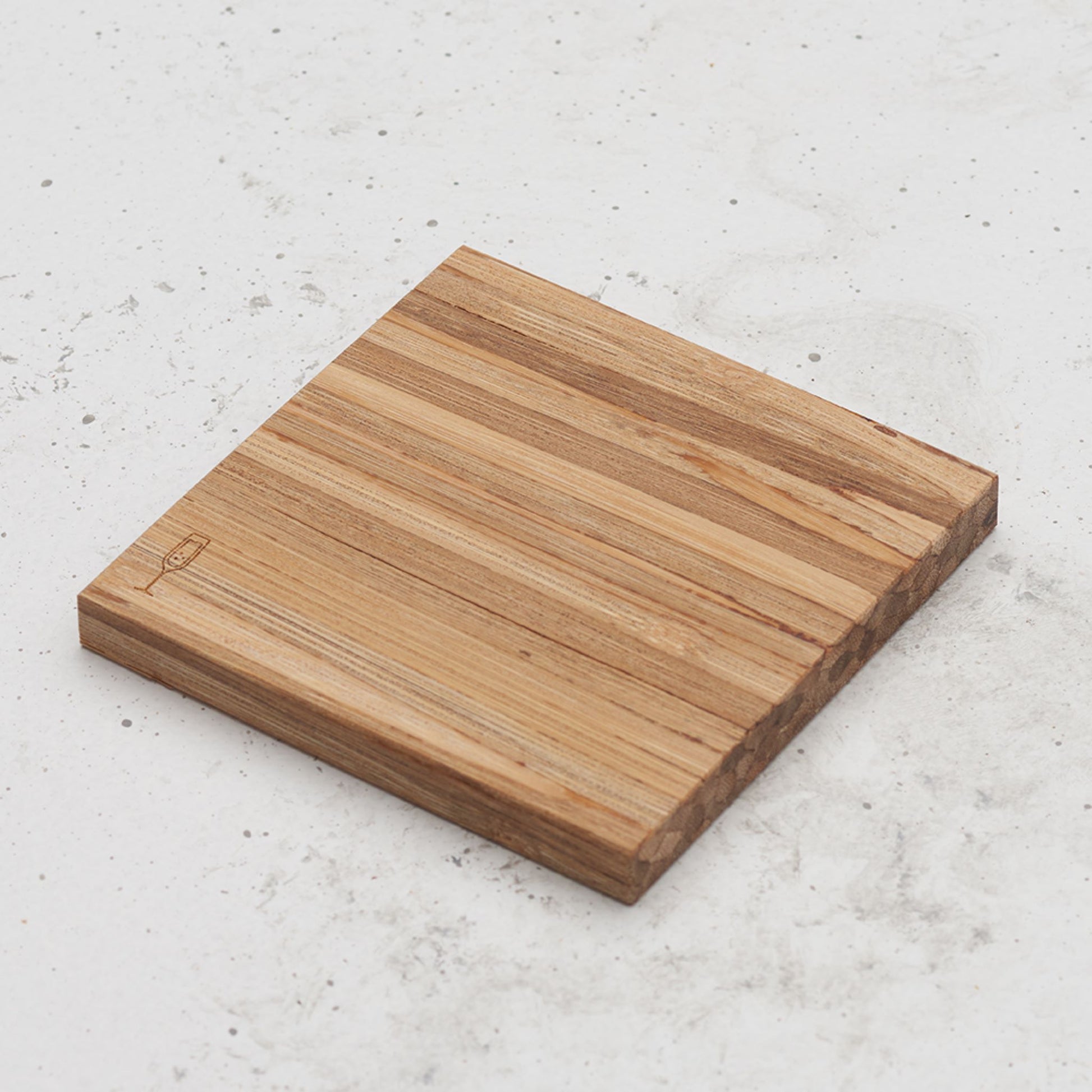 An over head view of one of the happy hour themed all day every day coasters with a champagne glass featured in the bottom left corner