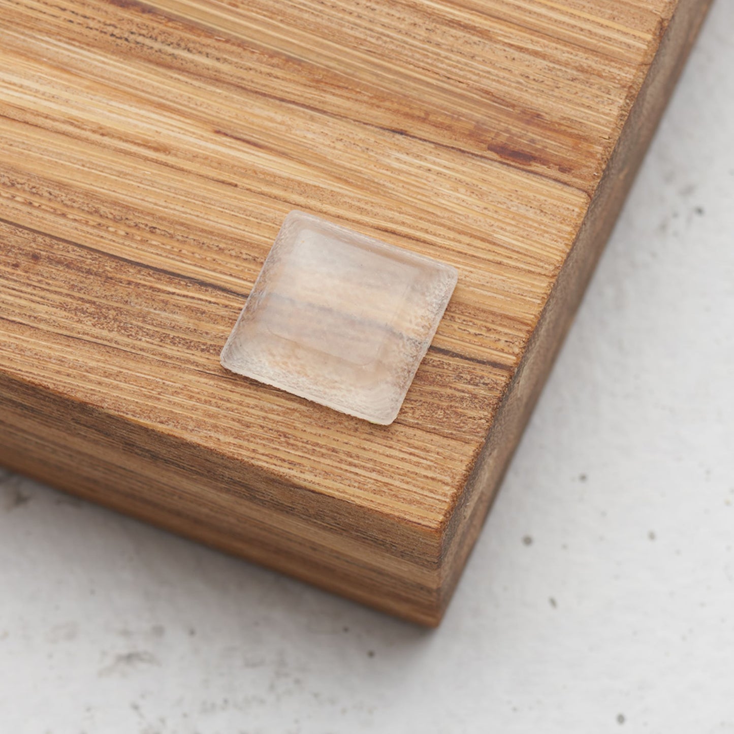 Close up view of the slip proof bumper attached to the back of the serving tray in lower corner