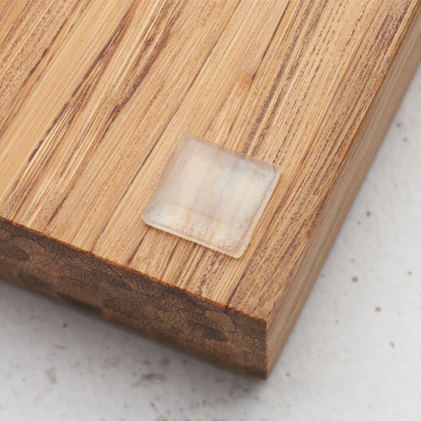 Close up view of the slip proof bumper attached to the back of the serving tray in lower corner