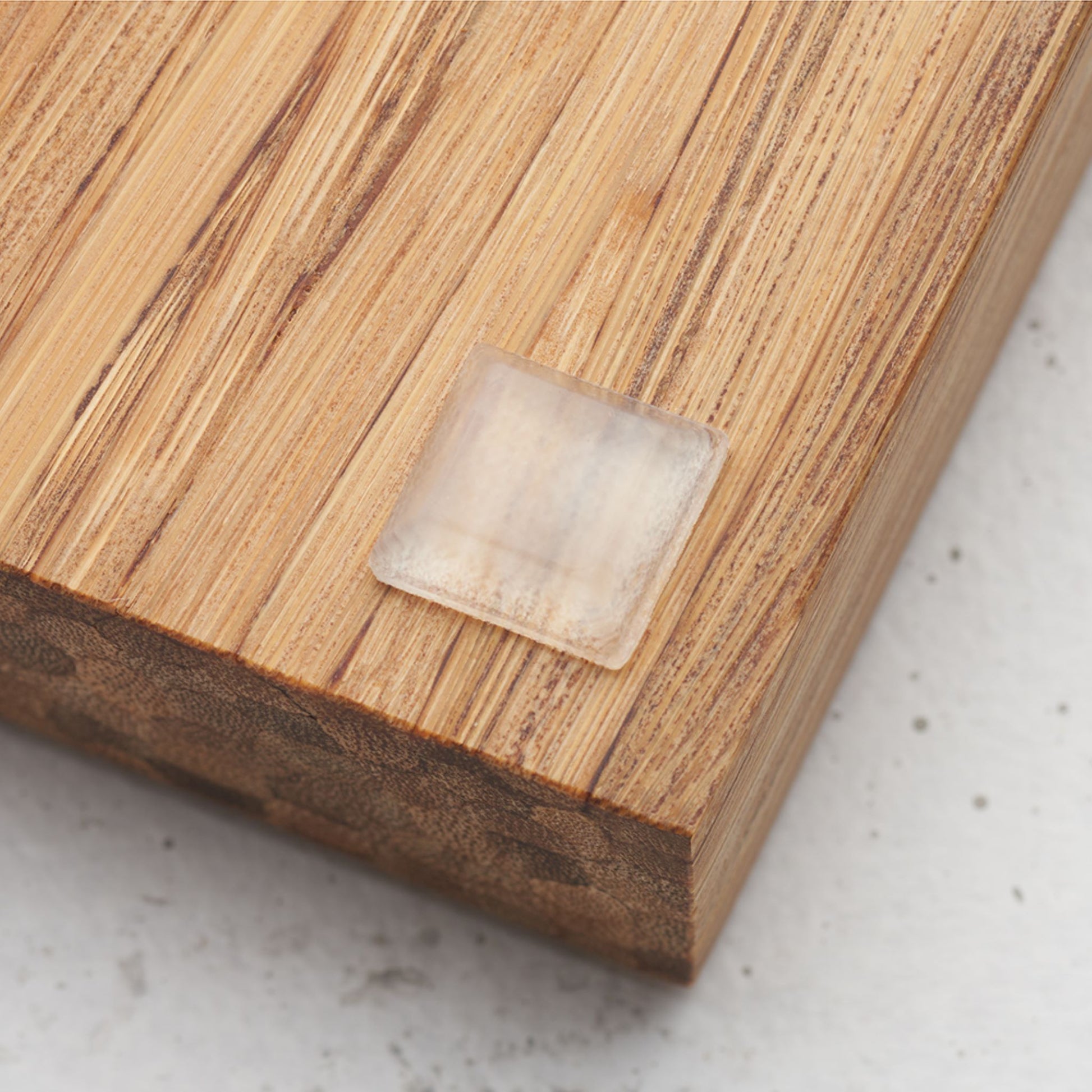 Close up view of the slip proof bumper attached to the back of the serving tray in lower corner