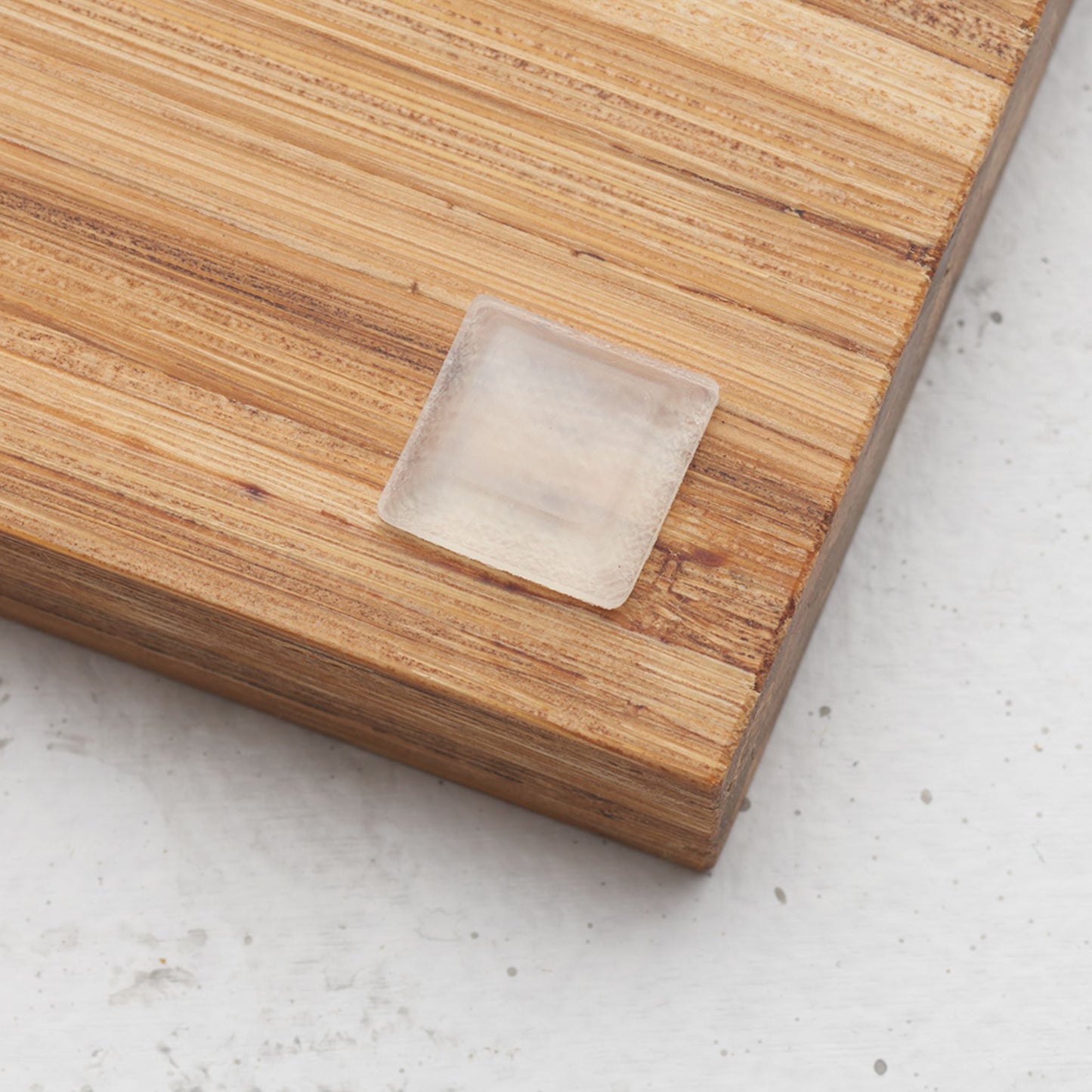 Close up view of the slip proof bumper attached to the back of the serving tray in lower corner