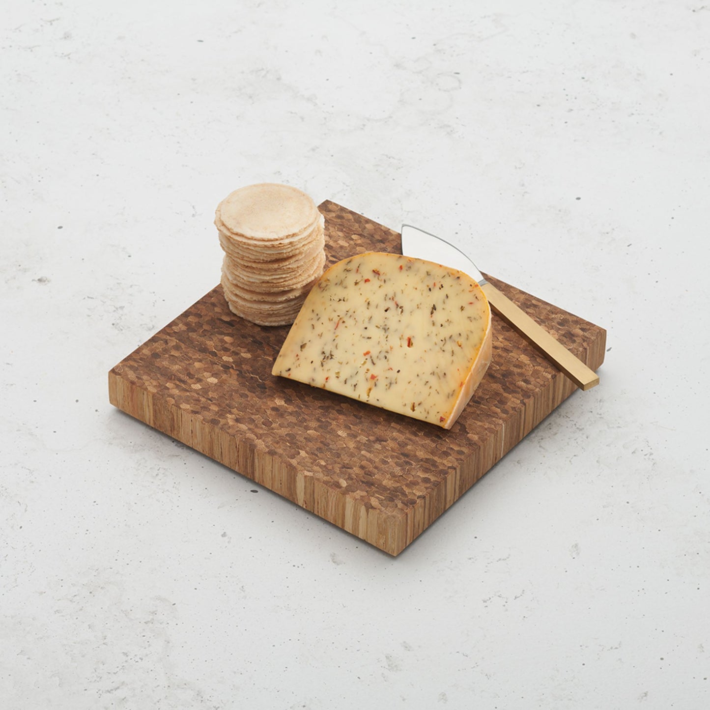 care to share cheese block sitting on a counter top with a cheese wedge placed on top