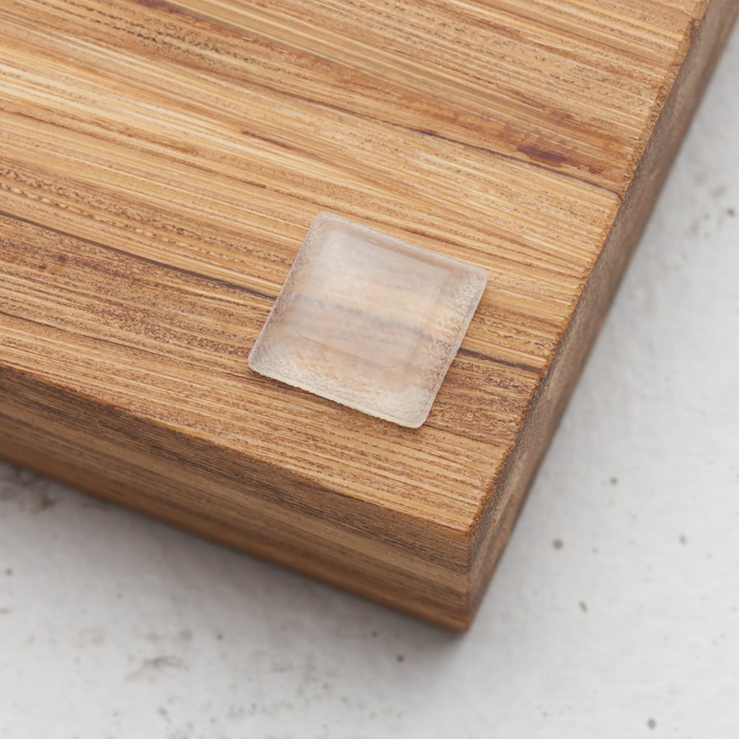 Close up view of the slip proof bumper attached to the back of the serving tray in lower corner