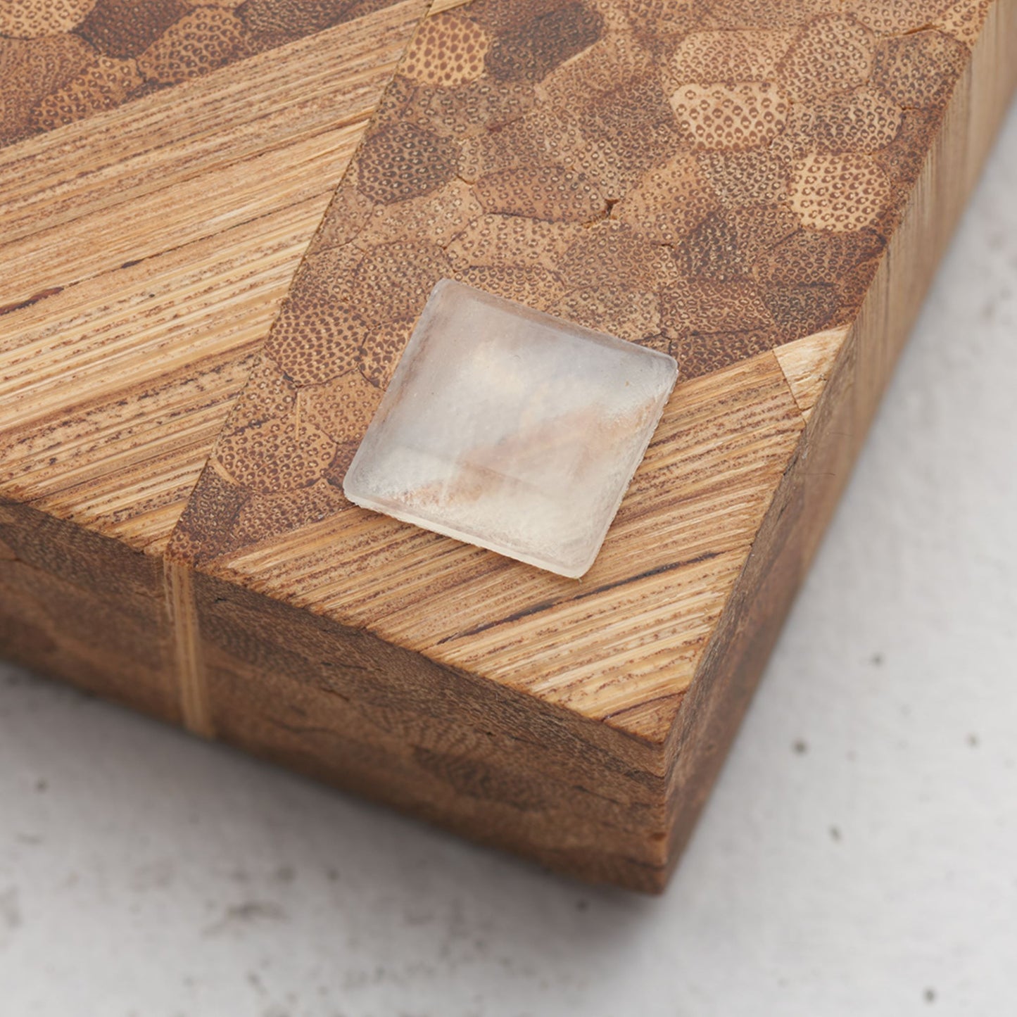 Close up view of the slip proof bumper attached to the back of the serving tray in lower corner