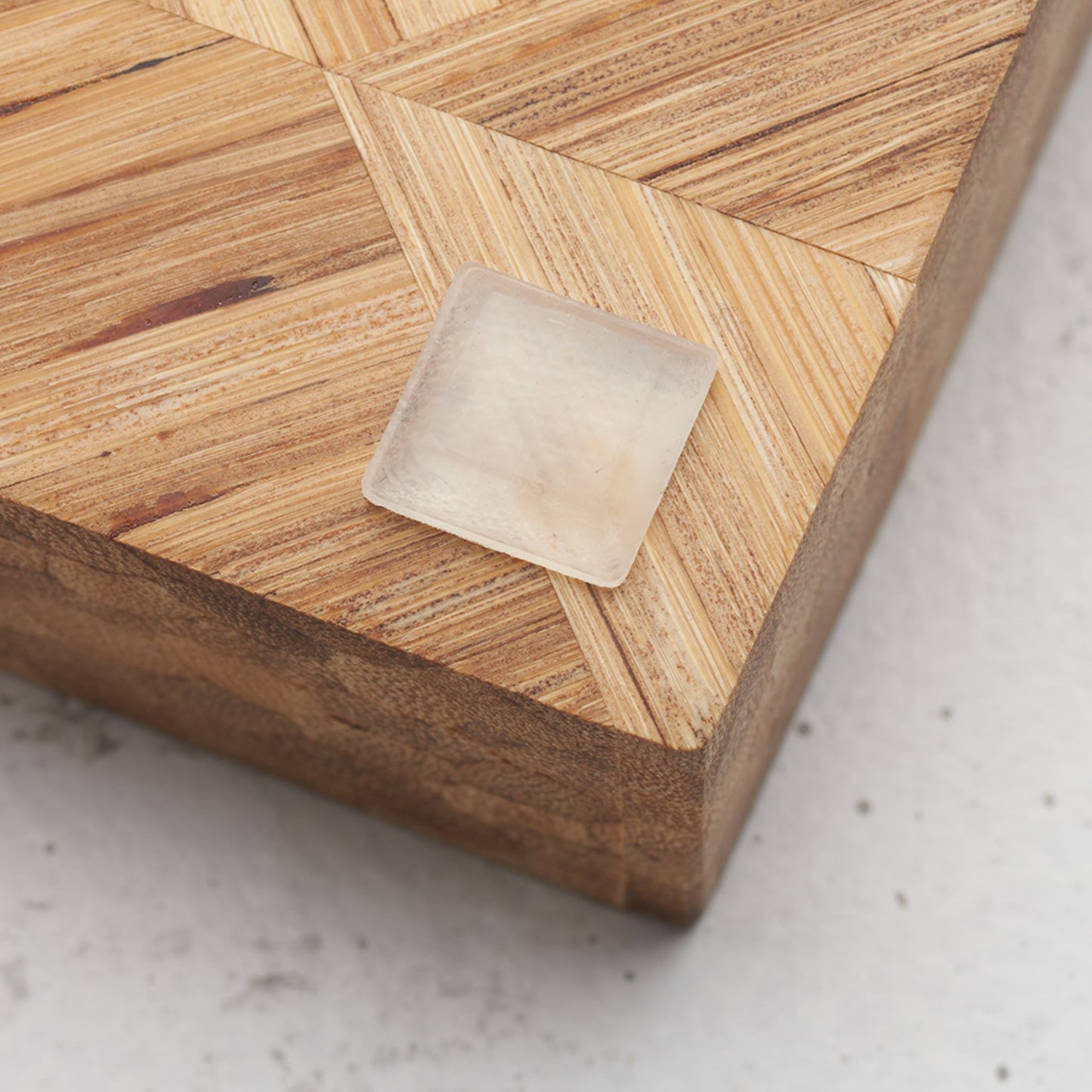 Close up view of the slip proof bumper attached to the back of the serving tray in lower corner