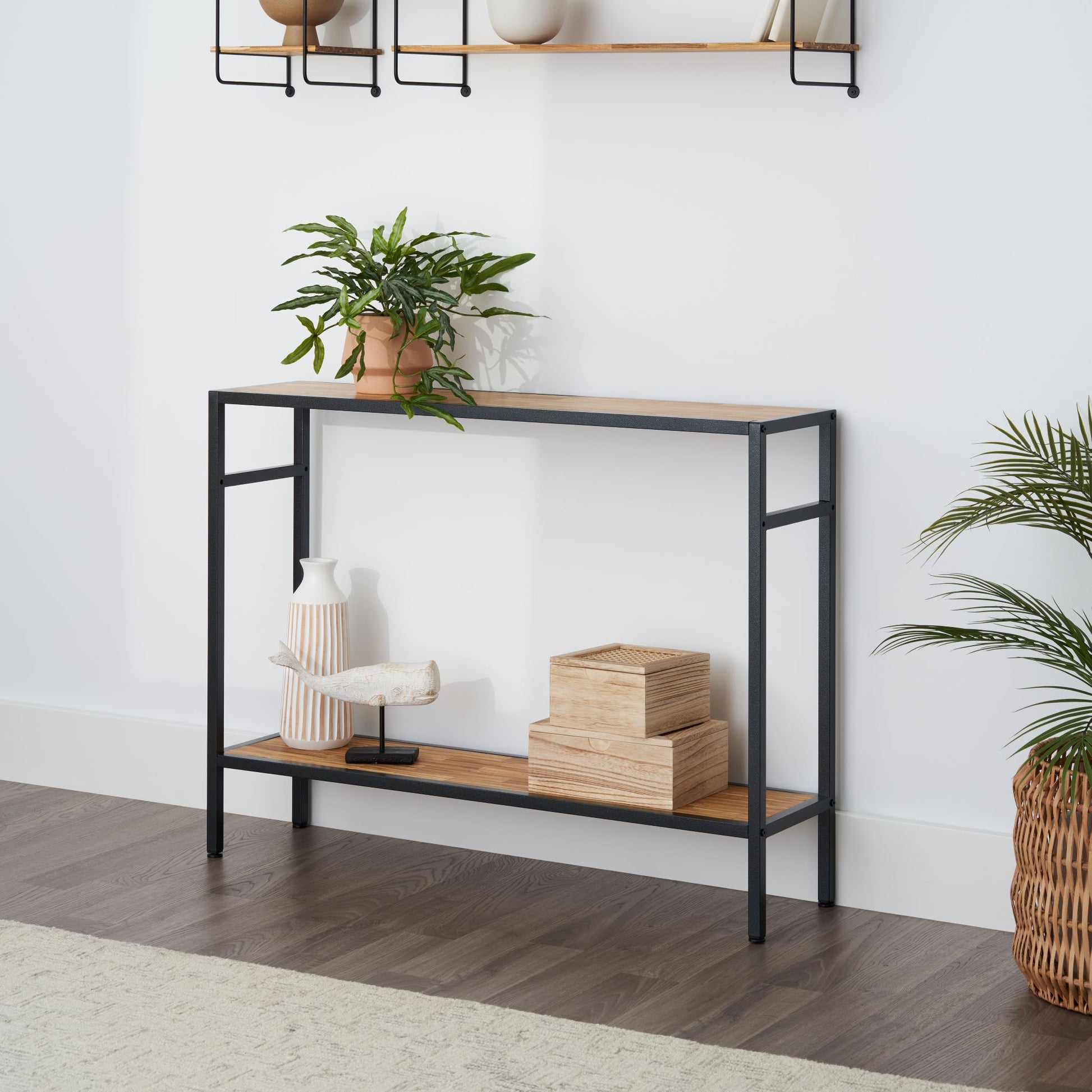 2 tier modern console table in a living room with items on its shelves