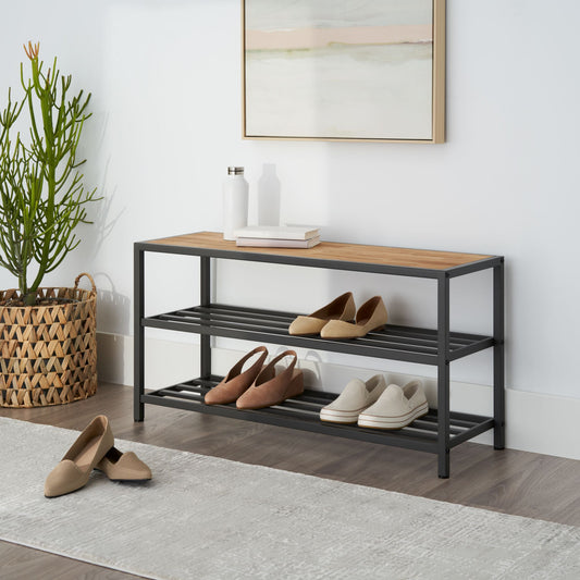 three tier shoe rack featuring a chopstick made wood top placed in a living room entry way with shoes on its shelves