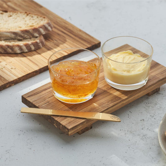 two glasses of sauce and a knife on the tray