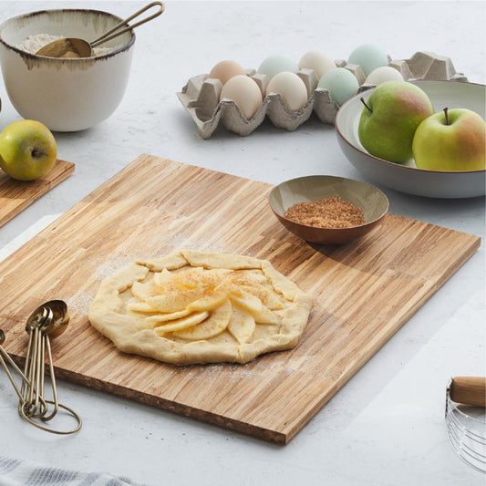 Preparing an apple pie to be baked on the medium everyday serving board