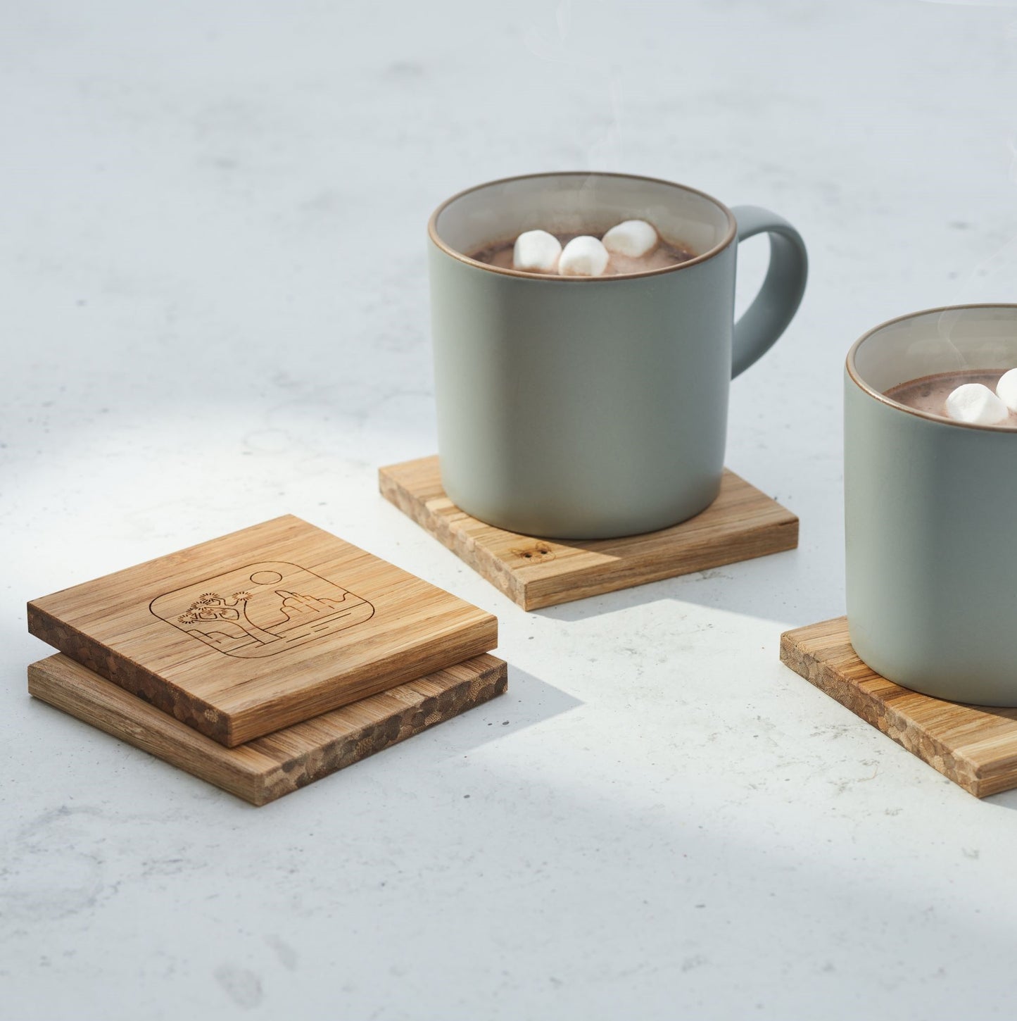 coasters and mugs of hot chocolate