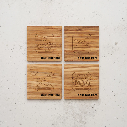 An overhead view of the backside of the entire nature themed all day every day coaster set sitting on a counter. Each coaster features a different laser-engraved nature scene—desert, ocean, mountains, and forest—with the placeholder text "Your Text Here" centered beneath the image.