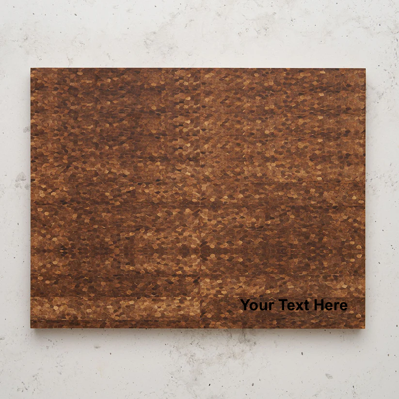 Overhead view of the large dark brown cutting board with a textured, mosaic-like grain pattern, suggesting an end-grain construction. The words "Your Text Here" are faintly overlaid in the bottom right corner of the board.