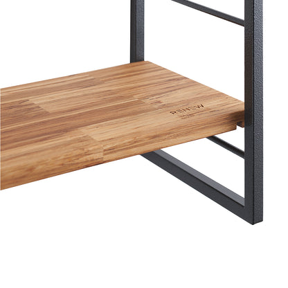 Close-up shot of a furniture piece, featuring a wooden shelf with a butcher-block style texture resting on a black metal frame. The word "RENEW" is subtly embossed or printed near the front edge of the wooden shelf.