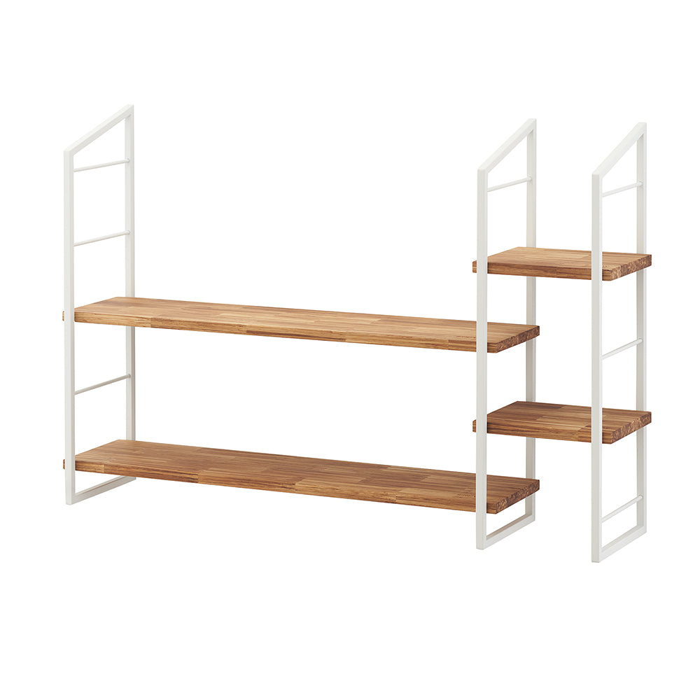 A modern, asymmetrical shelving unit featuring a white metal frame and natural wood shelves. The unit has two long, stacked shelves on the left and two shorter, stacked shelves on the right, providing varied display space.